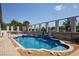 A kidney-shaped pool with a spa and statues. It also features a brick-paver pool deck at 13878 Allamanda Cir, Port Charlotte, FL 33981