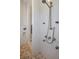 Modern shower featuring stone tile floors, multiple shower heads, and white stone walls at 13878 Allamanda Cir, Port Charlotte, FL 33981