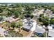 Aerial view of a cozy home nestled amongst verdant trees in a tranquil neighborhood setting at 1402 Freemont S St, Gulfport, FL 33707