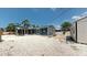 Backyard featuring an enclosed lanai, gravel, and a shed at 1402 Freemont S St, Gulfport, FL 33707