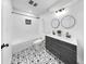 Modern bathroom with a shower/tub combo, patterned floor, and a floating double sink vanity at 1402 Freemont S St, Gulfport, FL 33707