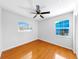 Well-lit bedroom featuring wood floors, ceiling fan, and bright windows at 1402 Freemont S St, Gulfport, FL 33707
