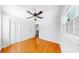 Empty bedroom features wood floors, a ceiling fan and a large window looking to the exterior at 1402 Freemont S St, Gulfport, FL 33707