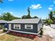 The well-manicured exterior of the house with red mulch and a well-kept lawn at 1402 Freemont S St, Gulfport, FL 33707