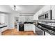 Well-lit kitchen featuring modern appliances, black granite counters, and white tiled backsplash at 1402 Freemont S St, Gulfport, FL 33707