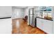 Bright kitchen with stainless steel refrigerator and white cabinets adjacent to the home's front entrance at 1402 Freemont S St, Gulfport, FL 33707