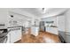 Kitchen seamlessly connects to the dining area with white cabinets, and a stainless steel refrigerator at 1402 Freemont S St, Gulfport, FL 33707