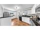 Well-lit kitchen featuring black countertops, white cabinetry, and stainless steel appliances at 1402 Freemont S St, Gulfport, FL 33707