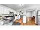 Bright kitchen features white cabinets, stainless steel appliances, and black granite countertops at 1402 Freemont S St, Gulfport, FL 33707
