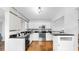 Bright kitchen features white cabinetry, black countertops, stainless steel appliances, and tile flooring at 1402 Freemont S St, Gulfport, FL 33707