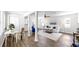 Sunlit living room with wood floors, white walls, a desk, and stylish decor at 1402 Freemont S St, Gulfport, FL 33707