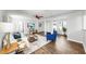 Bright living room featuring wood floors, white walls, a ceiling fan, and modern accents at 1402 Freemont S St, Gulfport, FL 33707