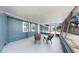 Comfortable screened porch with blue-gray exterior, and an airy atmosphere at 1402 Freemont S St, Gulfport, FL 33707