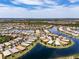 Aerial view of a lakeside Valencia Lakes community with manicured lawns and beautiful landscaping at 16106 Cedar Key Dr, Wimauma, FL 33598