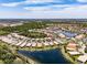 Bird's eye view of a lakeside Valencia Lakes community with scenic waterways and lush greenery at 16106 Cedar Key Dr, Wimauma, FL 33598