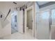 Well-lit bathroom featuring decorative walls, tiled floors, a glass shower and toilet stall at 16106 Cedar Key Dr, Wimauma, FL 33598