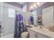 Bathroom featuring a vanity, mirror, shower, and decorative curtain at 16106 Cedar Key Dr, Wimauma, FL 33598