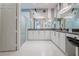 Bathroom with double sinks, decorative mirror, and glass door shower at 16106 Cedar Key Dr, Wimauma, FL 33598