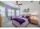Comfortable bedroom with a ceiling fan and decorative pillows on the bed at 16106 Cedar Key Dr, Wimauma, FL 33598