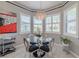 Breakfast nook has bright windows, pendant lighting and a modern glass table and chairs at 16106 Cedar Key Dr, Wimauma, FL 33598