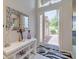 Bright entryway with white tile flooring and decorative mirror at 16106 Cedar Key Dr, Wimauma, FL 33598
