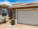 Home exterior shows the driveway and two-car garage with desert landscaping at 16106 Cedar Key Dr, Wimauma, FL 33598