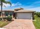 Inviting home with brick driveway, two-car garage, and carefully manicured landscaping at 16106 Cedar Key Dr, Wimauma, FL 33598