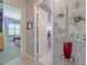 Hallway leading to a bedroom with unique patterned walls and art at 16106 Cedar Key Dr, Wimauma, FL 33598