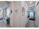 Bright hallway leads to kitchen and bedroom with view of modern interiors and stylish decor at 16106 Cedar Key Dr, Wimauma, FL 33598