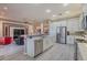 Spacious kitchen equipped with stainless steel appliances, white cabinetry, and a center island at 16106 Cedar Key Dr, Wimauma, FL 33598