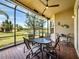 Covered and screened lanai features brick flooring and overlooks a tranquil lake view at 16106 Cedar Key Dr, Wimauma, FL 33598