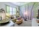 Inviting living room features a comfortable sofa, bamboo wall art, and stylish decor for relaxed living at 16106 Cedar Key Dr, Wimauma, FL 33598