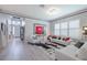 Bright and airy living room with modern white furniture, stylish decor, and elegant lighting at 16106 Cedar Key Dr, Wimauma, FL 33598