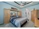 Spacious main bedroom featuring a large bed, built in cabinetry, and tray ceiling at 16106 Cedar Key Dr, Wimauma, FL 33598
