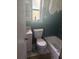 Small bathroom featuring green tile on walls, a white toilet, and a shower and bathtub at 1710 26Th S Ave, St Petersburg, FL 33712