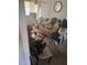 Cluttered living room with dated carpet, an overloaded couch, and a glass coffee table at 1710 26Th S Ave, St Petersburg, FL 33712