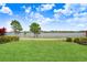 A beautiful green lawn with a gorgeous lake view in the back at 1830 Nature View Dr, Lutz, FL 33558