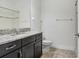 Bathroom featuring granite countertop vanity, modern fixtures and tile flooring at 1830 Nature View Dr, Lutz, FL 33558