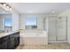 Bathroom features a soaking tub with shower, granite countertops, and modern fixtures at 1830 Nature View Dr, Lutz, FL 33558