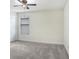 This bedroom has neutral carpeting, a ceiling fan, and a single window at 1830 Nature View Dr, Lutz, FL 33558
