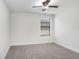 This bedroom has neutral carpeting, a ceiling fan, and a single window at 1830 Nature View Dr, Lutz, FL 33558