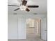 Bedroom featuring a ceiling fan, carpet floors, and view of upstairs hallway with wood railing at 1830 Nature View Dr, Lutz, FL 33558