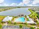 Stunning aerial view of the community pool and lake with a scenic walking trail surrounding the area at 1830 Nature View Dr, Lutz, FL 33558