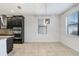 Dining area showcases modern stainless steel appliances, granite countertops, and sleek dark cabinets at 1830 Nature View Dr, Lutz, FL 33558