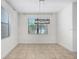 Bright dining area with a modern light fixture and natural light streaming through large windows at 1830 Nature View Dr, Lutz, FL 33558