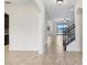 A spacious foyer with tile flooring and staircase leads to a bright, open living space at 1830 Nature View Dr, Lutz, FL 33558