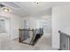 Upstairs hallway area featuring carpet floors and black metal/wood railing at 1830 Nature View Dr, Lutz, FL 33558