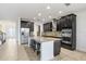 Kitchen features a large island with bar seating and granite countertops, complemented by sleek, dark cabinetry at 1830 Nature View Dr, Lutz, FL 33558