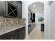 Modern kitchen boasts sleek, dark cabinets, granite countertops, and a stylish tile backsplash at 1830 Nature View Dr, Lutz, FL 33558