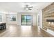 Spacious living room featuring sliding glass doors leading to the outdoors and a wood accent wall at 1830 Nature View Dr, Lutz, FL 33558